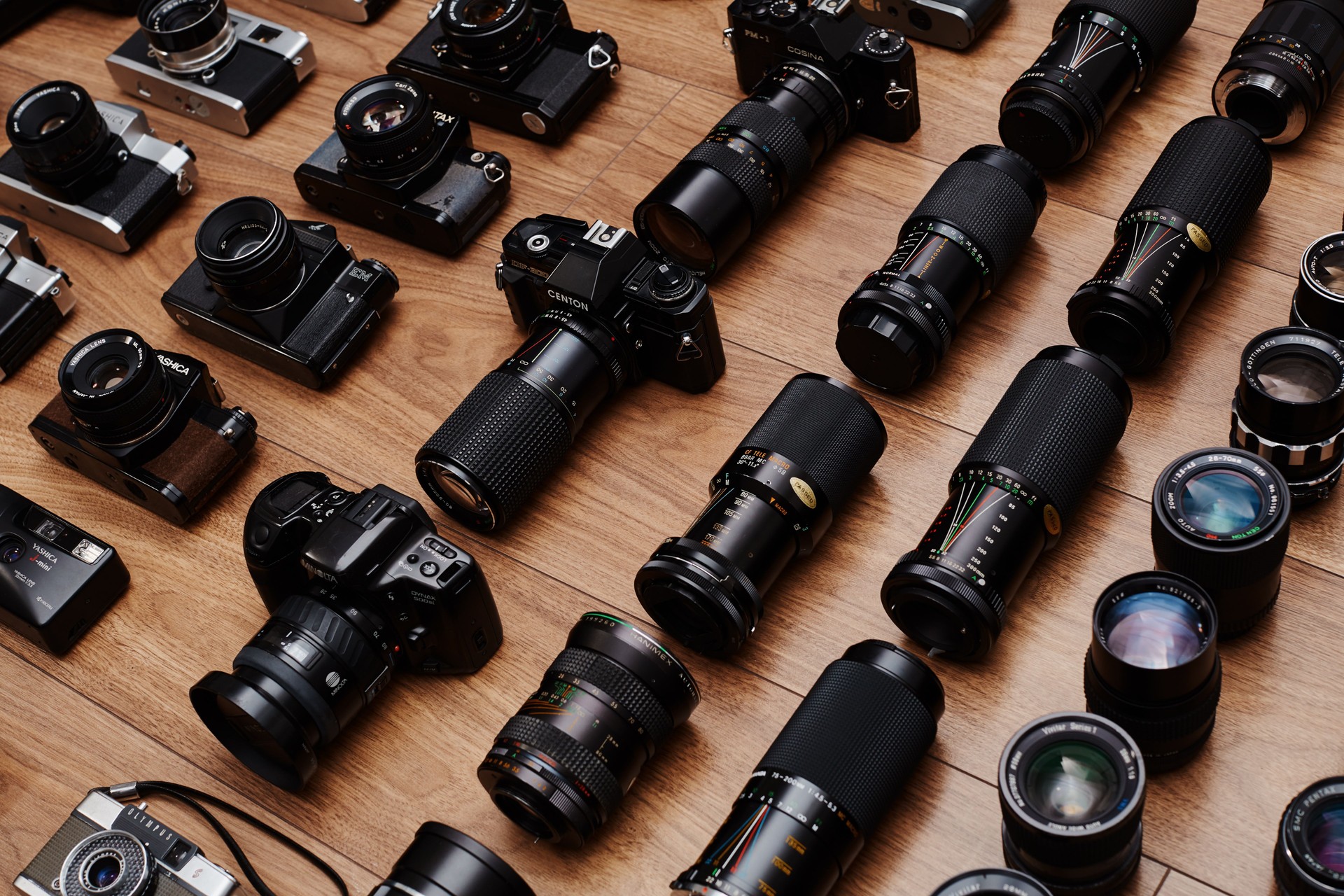 Top view of large group of analog vintage 35mm film cameras lying in arrangement close to each other